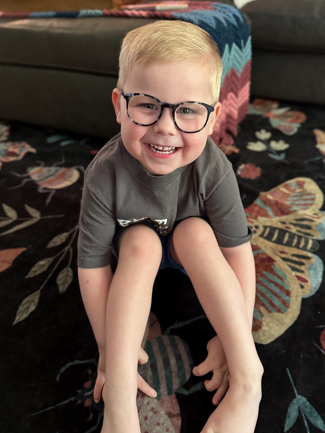 Felix crouched on the floor with a huge, open grin